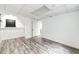 Bright basement with hardwood-style floors, drop ceiling tiles, and access to the stairs at 4274 S Fundy Way, Aurora, CO 80013