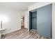 Cozy bedroom features stylish wood floors, a sliding door closet, and an open door to the kitchen at 4274 S Fundy Way, Aurora, CO 80013