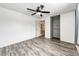 Spacious bedroom featuring hardwood-style flooring, closet with sliding doors, and ceiling fan at 4274 S Fundy Way, Aurora, CO 80013