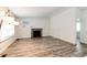 Bright living room with stylish wood-look floors, fireplace, and modern lighting at 4274 S Fundy Way, Aurora, CO 80013