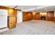 Large finished basement with wood paneling, a fireplace, and carpeted flooring at 797 W Briarwood Ave, Littleton, CO 80120