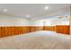Spacious finished basement with wood paneling and neutral carpeting at 797 W Briarwood Ave, Littleton, CO 80120