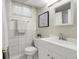 Bathroom features a white vanity, tiled walls, and a decorative mirror for a clean and modern design at 797 W Briarwood Ave, Littleton, CO 80120