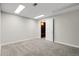 Neutrally painted bedroom with carpet and an adjoining wood paneled room at 797 W Briarwood Ave, Littleton, CO 80120