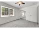 Cozy bedroom with neutral carpet, mirrored closet doors, and a large window at 797 W Briarwood Ave, Littleton, CO 80120