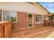 The house has a large wood deck, brick siding and multiple windows at 797 W Briarwood Ave, Littleton, CO 80120