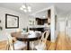 Inviting dining room with hardwood floors and an open view into the kitchen at 797 W Briarwood Ave, Littleton, CO 80120