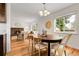 Open-concept dining area featuring hardwood floors with access to the living room at 797 W Briarwood Ave, Littleton, CO 80120