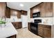 Modern kitchen with white countertops, dark wood cabinets, and stainless steel appliances at 797 W Briarwood Ave, Littleton, CO 80120