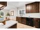 Well-lit kitchen with dark wood cabinetry, white countertops, and tile flooring at 797 W Briarwood Ave, Littleton, CO 80120