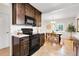 Well-equipped kitchen with dark wood cabinets, and open to the dining area at 797 W Briarwood Ave, Littleton, CO 80120