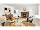 Cozy living room featuring a brick fireplace, hardwood floors, and stylish decor at 797 W Briarwood Ave, Littleton, CO 80120