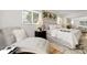 Comfortable bedroom featuring hardwood floors, natural light, and a seating area at 797 W Briarwood Ave, Littleton, CO 80120