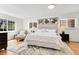 Bright bedroom with hardwood floors, windows, and neutral decor at 797 W Briarwood Ave, Littleton, CO 80120