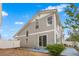 Exterior backyard view with blue patio and privacy fence at 20414 E 55Th Pl, Denver, CO 80249