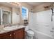 Well-lit bathroom featuring a bathtub, granite countertop and natural light from a window at 20414 E 55Th Pl, Denver, CO 80249