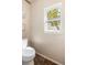 Bright bathroom featuring a toilet next to a window that brings natural light into the space at 20414 E 55Th Pl, Denver, CO 80249