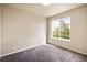 Cozy bedroom with neutral walls, plush carpeting, and a large window with a view, offering comfort at 20414 E 55Th Pl, Denver, CO 80249