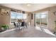 Charming dining area featuring a modern table set, bright natural light, and easy access to the backyard at 20414 E 55Th Pl, Denver, CO 80249