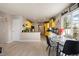 Open-concept kitchen and dining area featuring bright yellow cabinetry and modern finishes at 20414 E 55Th Pl, Denver, CO 80249