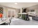 Bright living room with fireplace, sliding glass doors to the backyard, and hardwood style flooring at 20414 E 55Th Pl, Denver, CO 80249
