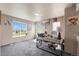 Sunlit office with large windows, neutral walls, and a gray carpet, offering a calming workspace at 20414 E 55Th Pl, Denver, CO 80249