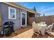 Back deck with grill, dining table, string lights, and privacy fencing at 2955 N Columbine St, Denver, CO 80205