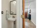 Bathroom with a pedestal sink, sleek mirror, and convenient towel holder at 2955 N Columbine St, Denver, CO 80205