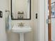 Bright bathroom showcasing a pedestal sink, modern fixtures, and a classic design at 2955 N Columbine St, Denver, CO 80205