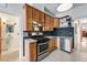 Traditional-style kitchen features updated stainless steel appliances and adjacent bathroom at 2955 N Columbine St, Denver, CO 80205