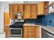 Traditional-style kitchen features warm wood cabinetry and stainless steel appliances, including a gas range at 2955 N Columbine St, Denver, CO 80205