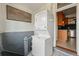 Compact laundry area features stacked washer and dryer units, conveniently located off the kitchen at 2955 N Columbine St, Denver, CO 80205