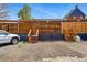 Spacious parking area with wooden fences and staircases leading to the house at 2955 N Columbine St, Denver, CO 80205
