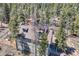 Aerial view of a home in a wooded setting, featuring a rooftop deck at 33 L Rd, Golden, CO 80403