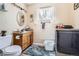 Well-lit bathroom features wood vanity, tile floors, and washer and dryer at 33 L Rd, Golden, CO 80403