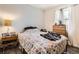 Bright bedroom with a comfortable quilt bed, wood-look flooring and a modern nightstand at 33 L Rd, Golden, CO 80403