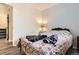 Cozy bedroom featuring a patterned quilt, warm lighting, and convenient access to the hallway at 33 L Rd, Golden, CO 80403