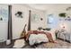 Bright bedroom featuring a guitar, cozy bed, and stylish decor at 33 L Rd, Golden, CO 80403