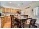 Eat-in kitchen featuring wood floors, breakfast table with seating, and wooden cabinets at 33 L Rd, Golden, CO 80403