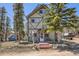 Charming home with stairs leading to the front door and mature landscaping at 33 L Rd, Golden, CO 80403