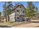 Charming two-story exterior with unique architectural details, surrounded by mature trees at 33 L Rd, Golden, CO 80403
