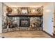 Charming stone fireplace with a log mantel is perfect for warming up on those cold nights at 33 L Rd, Golden, CO 80403