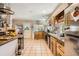 Open kitchen with tile flooring, stainless appliances, and a functional layout at 33 L Rd, Golden, CO 80403