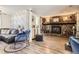 Cozy living room featuring a stone fireplace, hardwood floors, and lots of natural light at 33 L Rd, Golden, CO 80403