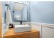 Stylish powder room with a wood countertop, vessel sink, and sleek black faucet at 2924 E 116Th Pl, Thornton, CO 80233