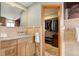 Bathroom view with granite countertop, wood cabinets, a walk-in closet, and a marble shower at 2924 E 116Th Pl, Thornton, CO 80233