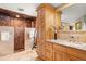 Luxurious bathroom featuring dual vanities, granite countertop, and walk-in shower with rainfall showerhead at 2924 E 116Th Pl, Thornton, CO 80233