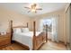 Bedroom with wooden floors, a four-poster bed, and a window offering natural light and neighborhood views at 2924 E 116Th Pl, Thornton, CO 80233