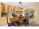 Inviting dining area with built-in cabinets, elegant light fixture, and seamless flow into the office at 2924 E 116Th Pl, Thornton, CO 80233