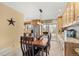 Dining area featuring a stylish light fixture, built-in cabinets, and a view of the kitchen at 2924 E 116Th Pl, Thornton, CO 80233